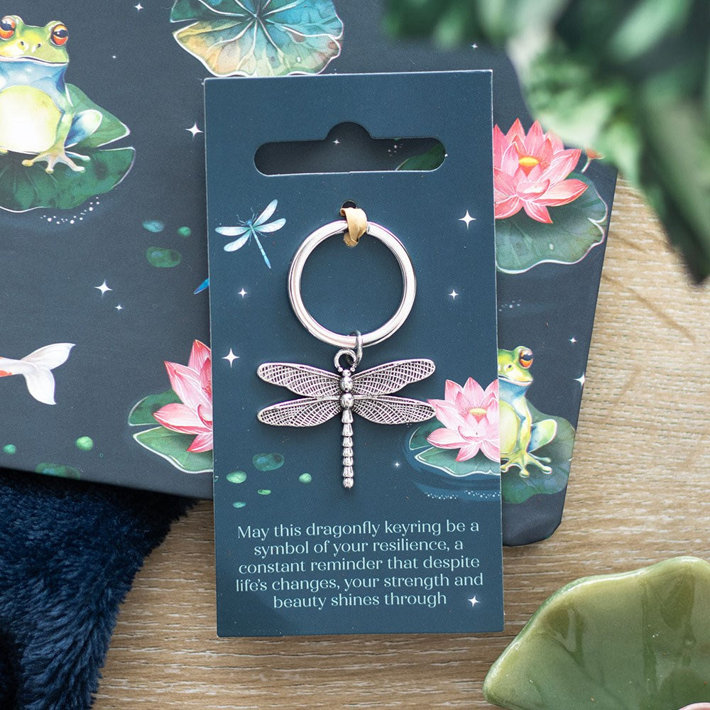 Dragonfly keyring lifestyle shot on pond-themed backing card with frogs and lotus flowers
