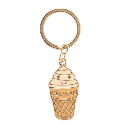 Ice cream cone enamel keyring charm close up on white background showing smiling soft serve cone with gold detailing