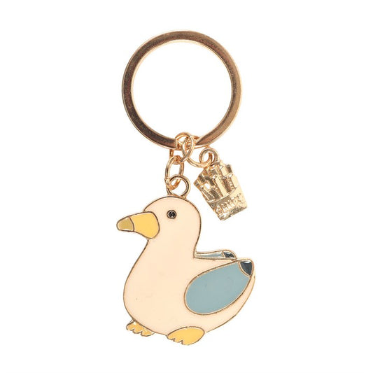 Seagull and chips enamel keyring charm close up on white background showing cream seagull and gold chips charm