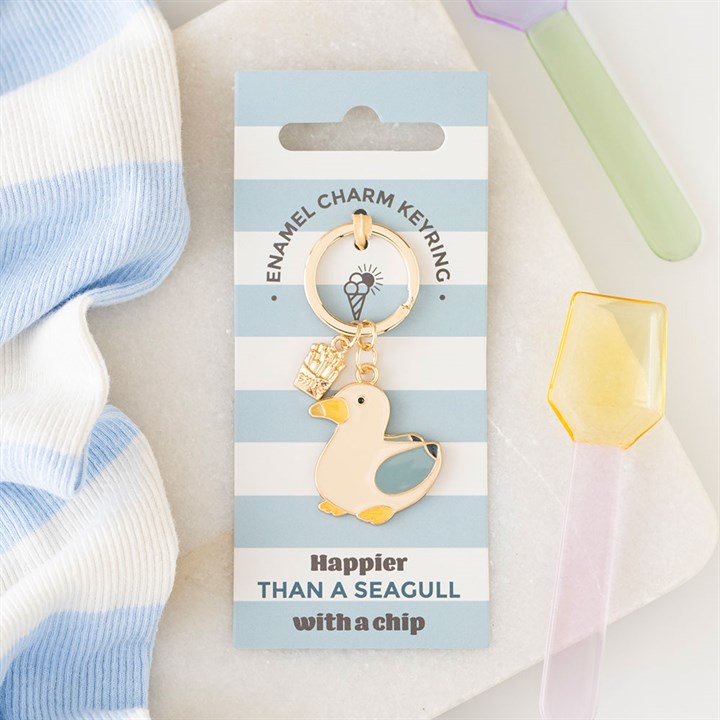 Seagull and chips enamel keyring lifestyle shot on nautical striped backing card with pastel accessories